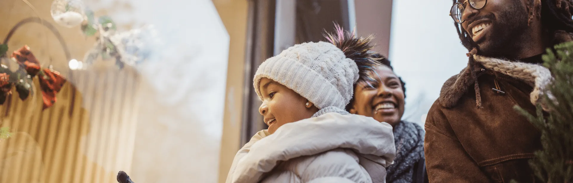 A family window shopping and wearing winter outfits.