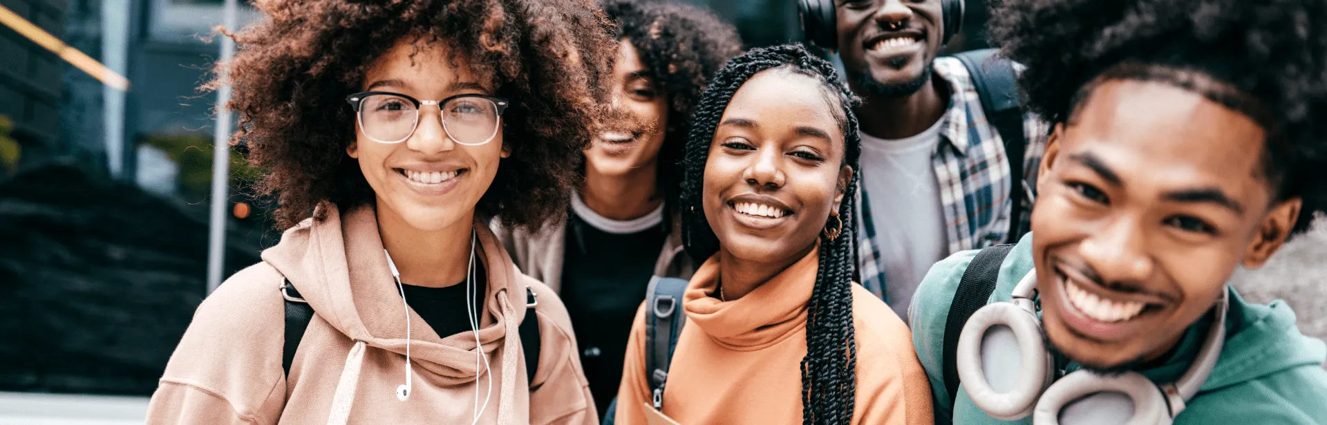 Several people looking at the camera and smiling together.